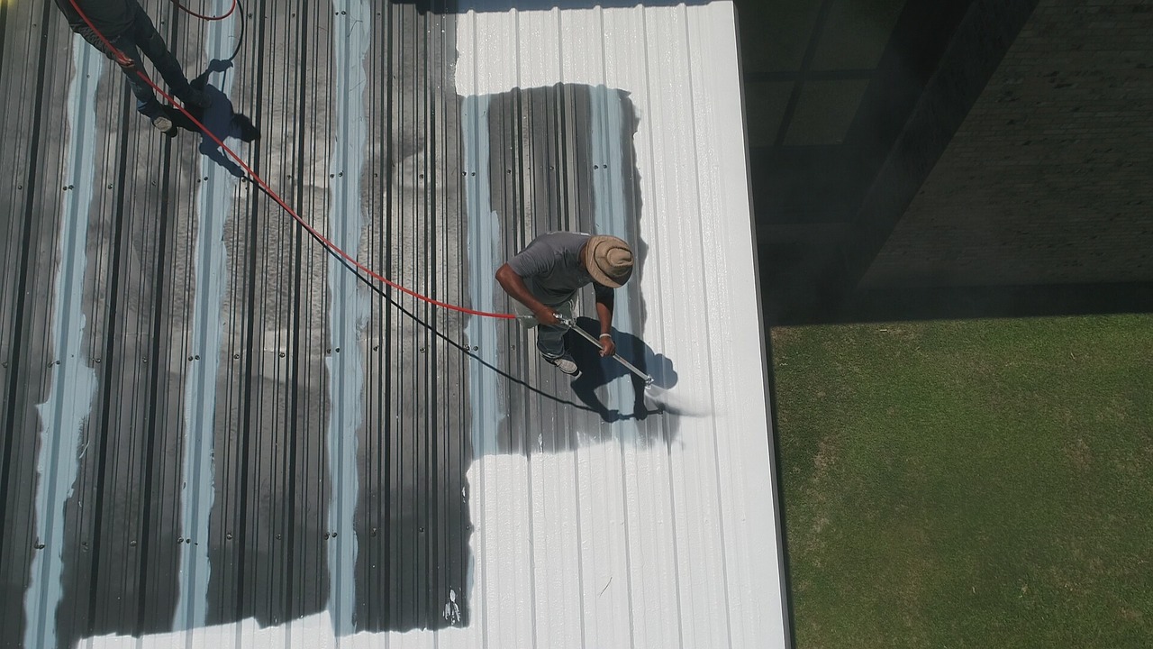 Photo of a man working on roof