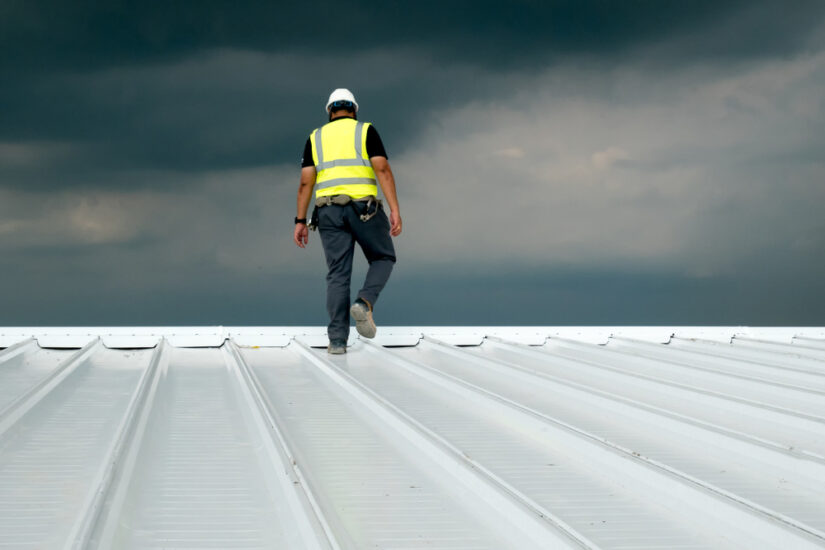 Photo of a worker walking on roof