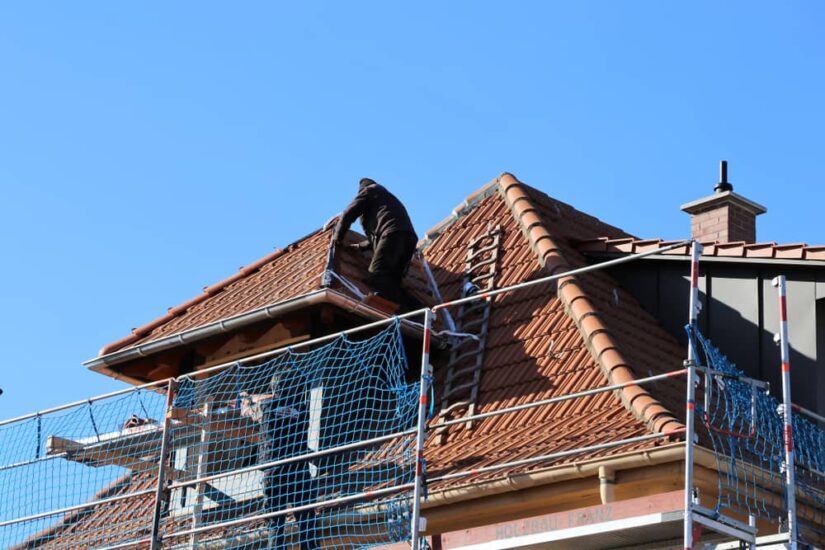 House With A Dark Brown Roof Being Repaired